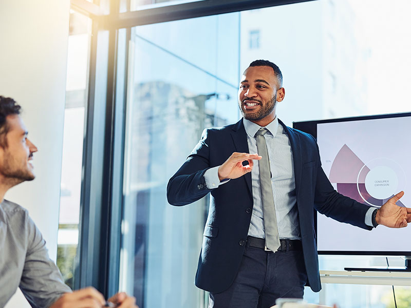 Smiling male realtor or broker shaking hand of excited buyers couple, negotiating about first house purchase or taking loan, insurance agent welcoming clients with handshake at consultation meeting Financial Advisor Presenting