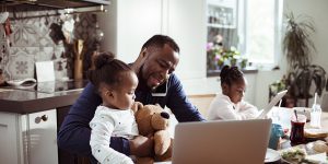 Young Family using a Laptop during Breakfast