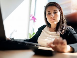 Woman using calculator