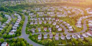 Top view aerial with from flying drone over residential district development buildings transportation