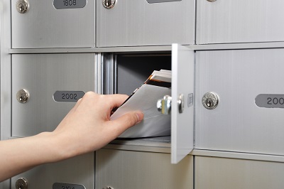Woman,Taking,Some,Letters,From,Mailbox man using calculator