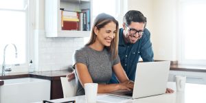 Shot of a young couple using a laptop together at home